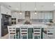 Modern kitchen with a large island, white countertops, stainless steel appliances, and stylish pendant lighting at 760 Annabell Ridge Rd, Minneola, FL 34715