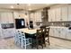 Modern kitchen boasts a large center island with bar stool seating, stainless steel appliances, and ample cabinets at 760 Annabell Ridge Rd, Minneola, FL 34715
