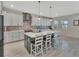 Bright kitchen with white cabinets, a large center island, stainless steel appliances, and sleek countertops at 760 Annabell Ridge Rd, Minneola, FL 34715