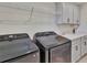 Laundry area showcases a modern washer and dryer with ample cabinet and countertop space at 760 Annabell Ridge Rd, Minneola, FL 34715