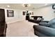 Inviting living room featuring neutral carpet, a comfortable sofa, and an entertainment setup, perfect for relaxation at 760 Annabell Ridge Rd, Minneola, FL 34715
