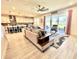 Spacious living room with tile floors, ceiling fan, modern furniture, and sliding glass doors to the backyard at 760 Annabell Ridge Rd, Minneola, FL 34715