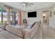 Cozy living room featuring a sectional sofa, modern decor, and a view of the outdoor patio at 760 Annabell Ridge Rd, Minneola, FL 34715