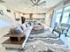 Bright open-plan living room with modern finishes, tile floors, ceiling fan, and a comfortable seating area at 760 Annabell Ridge Rd, Minneola, FL 34715