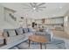 Open-concept living room with a comfortable sofa, a view of the kitchen, and a staircase at 760 Annabell Ridge Rd, Minneola, FL 34715