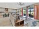 Inviting living room with sliding glass doors, a comfortable sofa, and a view into the modern kitchen at 760 Annabell Ridge Rd, Minneola, FL 34715