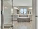 Luxurious main bathroom with a glass-enclosed shower and a deep soaking tub at 760 Annabell Ridge Rd, Minneola, FL 34715