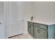 Mud room with painted cabinets, a sleek counter, and easy access to the laundry area at 760 Annabell Ridge Rd, Minneola, FL 34715