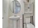 Elegant powder room features pedestal sink and decorative cabinet at 760 Annabell Ridge Rd, Minneola, FL 34715