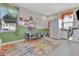 Bright playroom with a colorful rug, -sized furniture, and ample space for creative activities at 760 Annabell Ridge Rd, Minneola, FL 34715