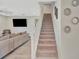 Bright staircase with carpeted stairs leading to the upper floor and access to the living room at 760 Annabell Ridge Rd, Minneola, FL 34715