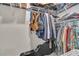 Walk-in closet with metal shelving full of hanging clothes and storage for bags and accessories at 760 Annabell Ridge Rd, Minneola, FL 34715