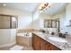 Luxurious bathroom with double vanity, granite countertops, soaking tub, and glass-enclosed shower at 7824 Loxahatchee Ct, Reunion, FL 34747