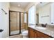 Bright bathroom featuring a glass-enclosed shower, granite countertops, and modern fixtures at 7824 Loxahatchee Ct, Reunion, FL 34747