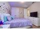 A stylish bedroom featuring a comfortable bed, modern lighting, and a cozy atmosphere at 7824 Loxahatchee Ct, Reunion, FL 34747