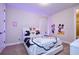 Whimsical bedroom featuring a white bed, fun Disney decor, and plush carpeting at 7824 Loxahatchee Ct, Reunion, FL 34747
