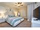 Comfortable bedroom features a plush bed, ceiling fan, and decorative accents at 7824 Loxahatchee Ct, Reunion, FL 34747