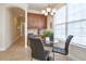 Bright breakfast nook with a round glass table, leather chairs, and a window view at 7824 Loxahatchee Ct, Reunion, FL 34747