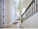Bright foyer with tile flooring, a decorative glass door, and staircase with iron railings at 7824 Loxahatchee Ct, Reunion, FL 34747