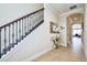 Hallway features tile flooring, decorative mirror, and arched entryway at 7824 Loxahatchee Ct, Reunion, FL 34747