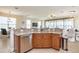 Kitchen with a stainless steel dishwasher, wood cabinetry, and a sink with granite countertops at 7824 Loxahatchee Ct, Reunion, FL 34747