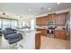 Open kitchen features a bar-top island with seating, stainless steel appliances, and wood cabinets at 7824 Loxahatchee Ct, Reunion, FL 34747
