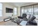 Comfortable living room with a modern sofa, glass tables, and a view of the outdoor scenery at 7824 Loxahatchee Ct, Reunion, FL 34747