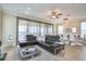 Cozy living room with stylish leather seating and an adjacent dining area, filled with natural light at 7824 Loxahatchee Ct, Reunion, FL 34747