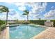 Relaxing pool area surrounded by well-manicured landscaping and a built-in grill at 7824 Loxahatchee Ct, Reunion, FL 34747