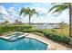 Beautiful pool and spa with lake views and lush landscaping at 7824 Loxahatchee Ct, Reunion, FL 34747