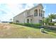Spacious home with a manicured lawn, mature landscaping, and a side view of the house and three-car garage at 7824 Loxahatchee Ct, Reunion, FL 34747