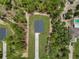 Aerial view of a home featuring a long driveway and surrounded by lush greenery at 8459 Sw 138Th Ter, Dunnellon, FL 34432