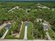 Aerial view of the home nestled within a lush green neighborhood at 8459 Sw 138Th Ter, Dunnellon, FL 34432