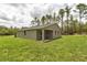 Back exterior featuring a covered patio and lush grassy yard at 8459 Sw 138Th Ter, Dunnellon, FL 34432