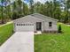 Charming one story home with an attached garage, beautiful landscaping and a sidewalk leading to the front door at 8459 Sw 138Th Ter, Dunnellon, FL 34432