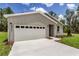 Single-story home boasting a two-car garage, neutral siding, and a well-maintained lawn at 8459 Sw 138Th Ter, Dunnellon, FL 34432