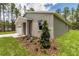 A charming home with a two-car garage, beautiful landscaping and lush green grass in the front yard at 8459 Sw 138Th Ter, Dunnellon, FL 34432