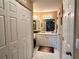 Bright bathroom featuring vanity, mirror, and white tiled floor at 8830 Coral Palms Ct # A, Kissimmee, FL 34747