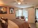 Comfortable bedroom with a plush bed, ceiling fan, and sliding glass doors at 8830 Coral Palms Ct # A, Kissimmee, FL 34747