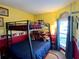 ' bedroom with a bunk bed, decorative walls, and window at 8830 Coral Palms Ct # A, Kissimmee, FL 34747