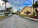 Welcoming entrance to the community with guardhouse and lush palm trees at 8830 Coral Palms Ct # A, Kissimmee, FL 34747