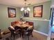 Dining area with bench seating, comfortable chairs, and decoratively framed pictures at 8830 Coral Palms Ct # A, Kissimmee, FL 34747