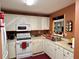 Practical kitchen layout featuring modern white appliances and convenient sink placement at 8830 Coral Palms Ct # A, Kissimmee, FL 34747