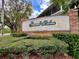 Welcoming community sign at Grand Palms with manicured landscaping and a bright blue sky at 8830 Coral Palms Ct # A, Kissimmee, FL 34747