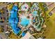 Aerial view of community pool with lazy river, water slides, splash pad, beach volleyball, and pool-side restaurant at 926 Paradise Dr, Davenport, FL 33897