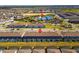 Aerial view of multiple units and community amenities; pool, recreation center, and townhouse buildings at 926 Paradise Dr, Davenport, FL 33897