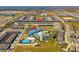 Aerial view showcasing the community amenities including a large pool, recreation center, and multiple townhome buildings at 926 Paradise Dr, Davenport, FL 33897