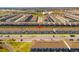 Expansive aerial view of townhomes showcases a well-planned community with ample parking and manicured lawns at 926 Paradise Dr, Davenport, FL 33897