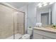 Bright bathroom with granite countertop vanity and enclosed tiled shower at 926 Paradise Dr, Davenport, FL 33897