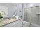 Modern bathroom with granite countertop, glass-enclosed shower, and neutral tile at 926 Paradise Dr, Davenport, FL 33897